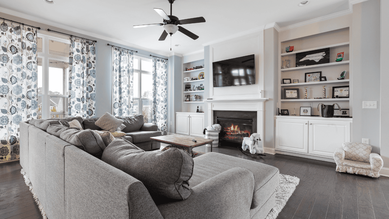 Modern Living Room with Fireplace and Shelves Spacious living room with large windows, fireplace, and built-in shelves for a cozy atmosphere.