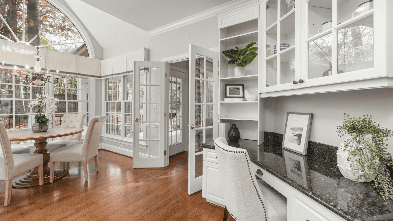 Bright and Elegant Kitchen with White Cabinets Spacious kitchen with white cabinetry, large windows, and hardwood floors.